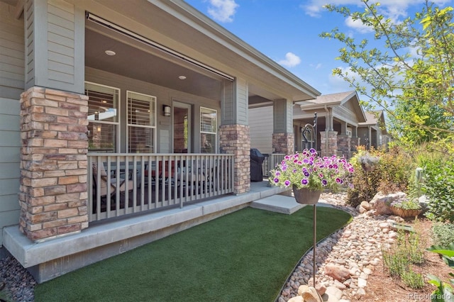 1976 Canyonpoint Ln, Castle Pines, CO 80108 - doorway to property with covered porch and stone siding