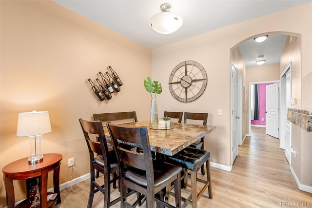 dining space with light hardwood / wood-style floors