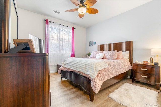 bedroom with ceiling fan and light wood-type flooring