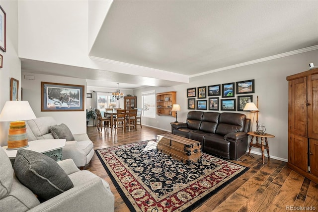 living room with baseboards, a chandelier, dark wood-type flooring, and ornamental molding