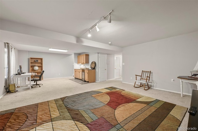 interior space featuring light carpet, rail lighting, and baseboards