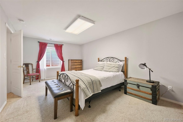 carpeted bedroom featuring baseboards