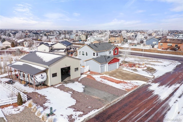 snowy aerial view with a residential view