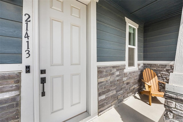 view of exterior entry featuring a porch