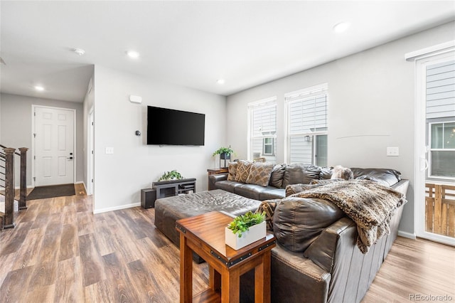 living area with recessed lighting, stairway, baseboards, and wood finished floors