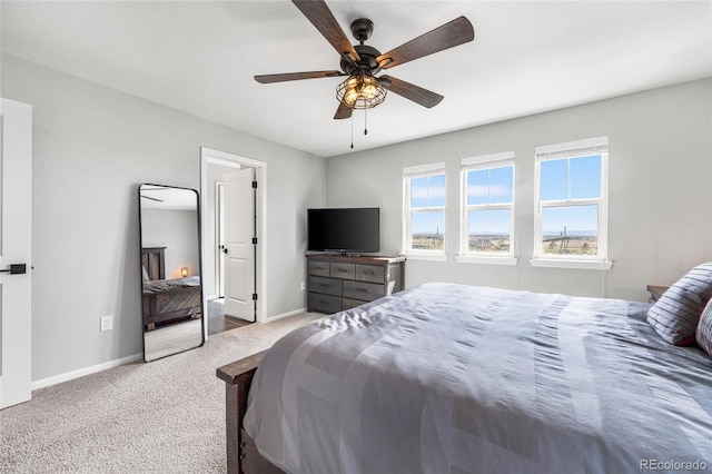 bedroom with carpet floors, baseboards, and a ceiling fan