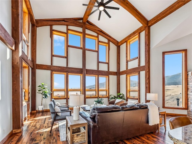 living area with wood-type flooring, high vaulted ceiling, and ceiling fan