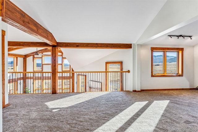 bonus room featuring carpet floors, vaulted ceiling with beams, a ceiling fan, and plenty of natural light