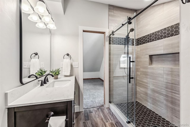 bathroom with a shower stall, vanity, and wood finished floors