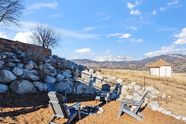 view of yard with a mountain view and an outbuilding