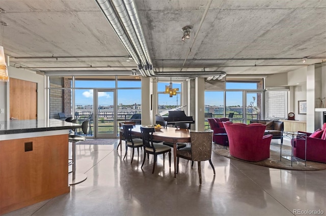 1610 Little Raven St Unit 502, Denver, CO 80202 - dining room featuring healthy amount of natural light, finished concrete floors, and a city view
