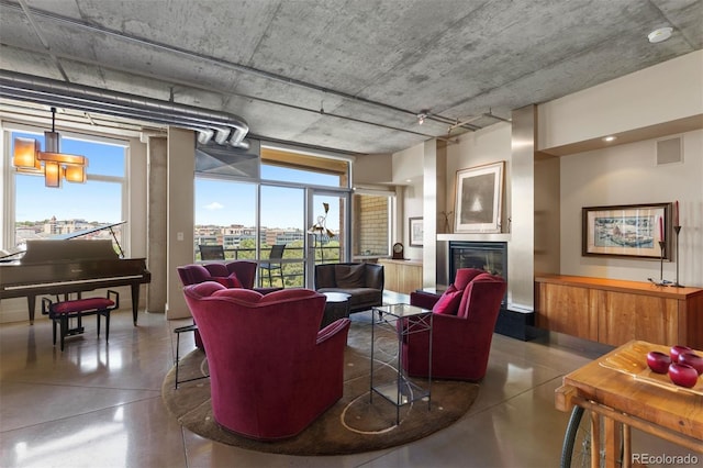 1610 Little Raven St Unit 502, Denver, CO 80202 - living room featuring finished concrete floors, plenty of natural light, and a glass covered fireplace