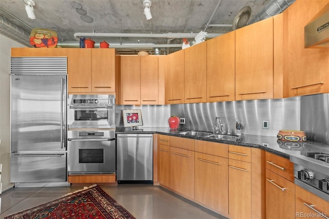 1610 Little Raven St Unit 502, Denver, CO 80202 - kitchen featuring appliances with stainless steel finishes, dark stone countertops, extractor fan, and finished concrete flooring