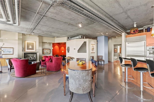 1610 Little Raven St Unit 502, Denver, CO 80202 - dining space featuring finished concrete flooring and a fireplace