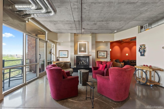 1610 Little Raven St Unit 502, Denver, CO 80202 - living area featuring a fireplace with raised hearth, plenty of natural light, and finished concrete floors