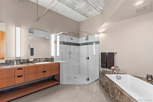 1610 Little Raven St Unit 502, Denver, CO 80202 - bathroom with double vanity, a bath, a shower stall, and tile patterned floors