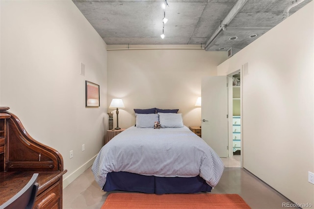 1610 Little Raven St Unit 502, Denver, CO 80202 - bedroom featuring track lighting and finished concrete flooring
