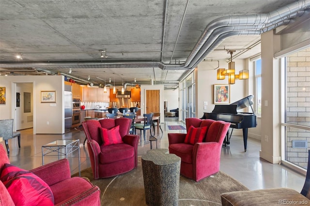 1610 Little Raven St Unit 502, Denver, CO 80202 - living area featuring baseboards and finished concrete flooring