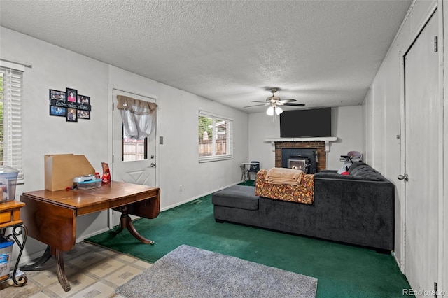 4550 E 121st Pl, Thornton, CO 80241 - living area with a ceiling fan, carpet flooring, a brick fireplace, a textured ceiling, and baseboards