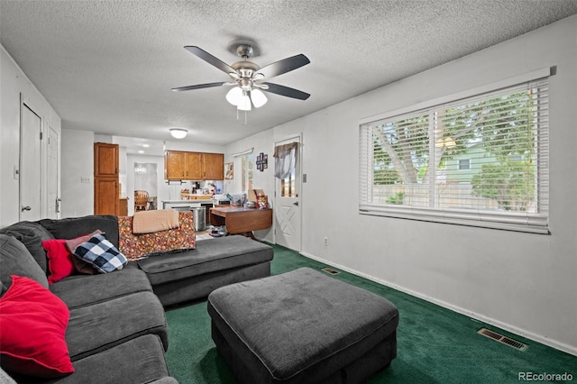 4550 E 121st Pl, Thornton, CO 80241 - living room with carpet floors, ceiling fan, baseboards, and a textured ceiling