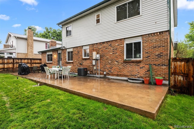4550 E 121st Pl, Thornton, CO 80241 - back of house with brick siding, a patio, and central AC