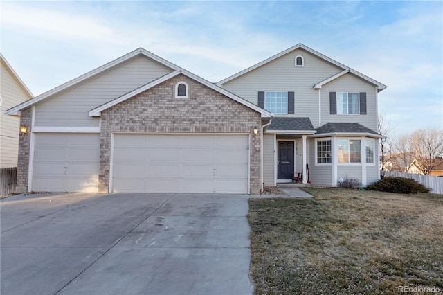 traditional home with a shingled roof, brick siding, driveway, a front yard, and an attached garage