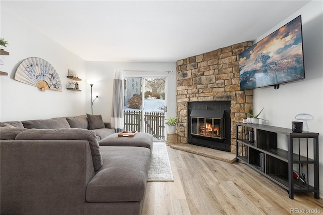 living room featuring light wood-style floors and a fireplace