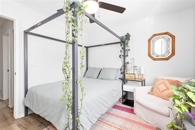 bedroom with light wood-style flooring and ceiling fan