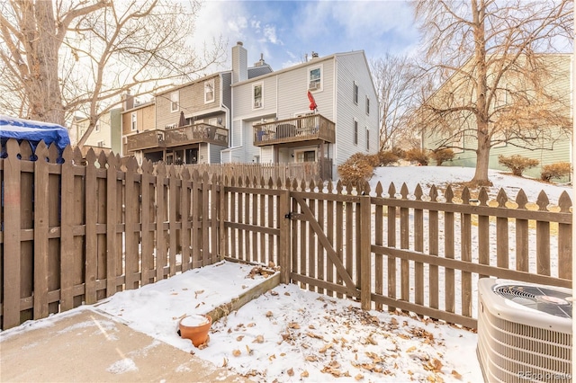 exterior space featuring central AC unit, fence, and a gate