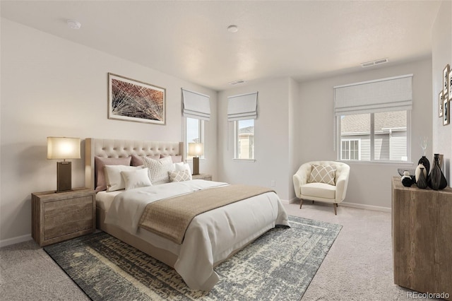 bedroom with multiple windows and light colored carpet