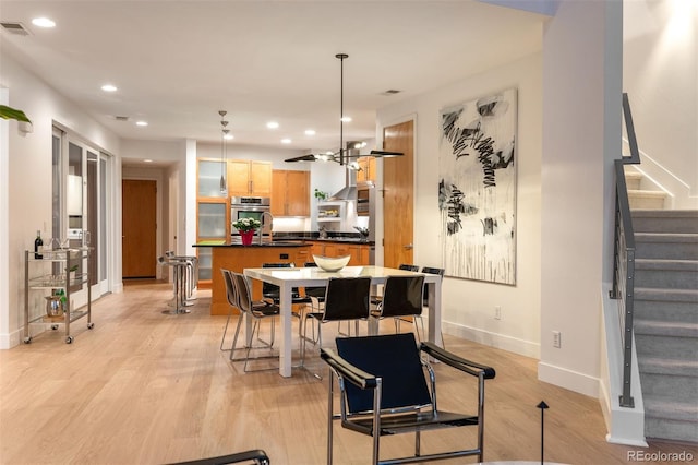 8071 E 29th Ave, Denver, CO 80238 - dining space featuring stairs, light wood-style floors, recessed lighting, and baseboards