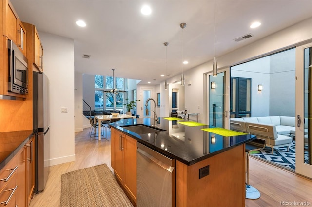 8071 E 29th Ave, Denver, CO 80238 - kitchen with stainless steel appliances, a sink, open floor plan, light wood finished floors, and recessed lighting