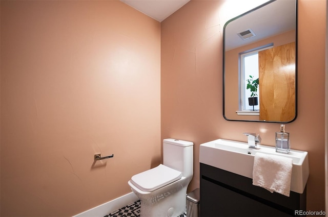 8071 E 29th Ave, Denver, CO 80238 - half bathroom featuring toilet, vanity, and baseboards