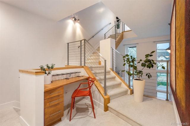 8071 E 29th Ave, Denver, CO 80238 - stairway with carpet flooring, built in desk, and baseboards