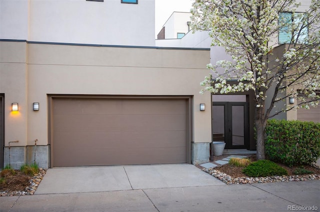 8071 E 29th Ave, Denver, CO 80238 - view of front of house with stucco siding, driveway, and a garage