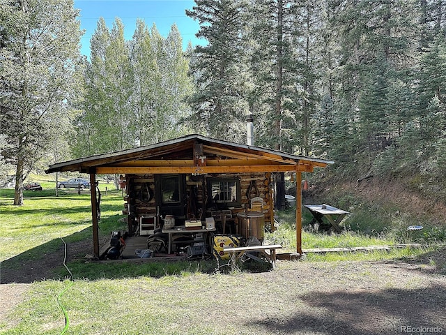 view of outbuilding featuring a lawn