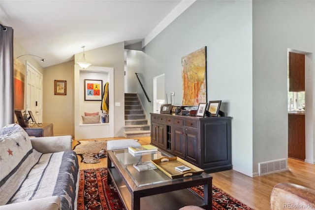 living room featuring light hardwood / wood-style flooring and lofted ceiling