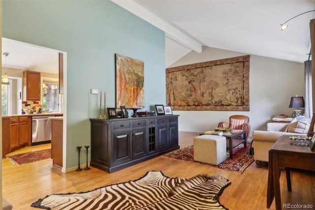 living room featuring light hardwood / wood-style flooring and lofted ceiling with beams