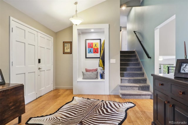 foyer entrance featuring light hardwood / wood-style floors and vaulted ceiling