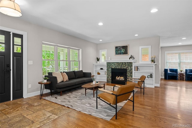 2485 S Fillmore St, Denver, CO 80210 - living room with recessed lighting, a tiled fireplace, baseboards, and wood finished floors
