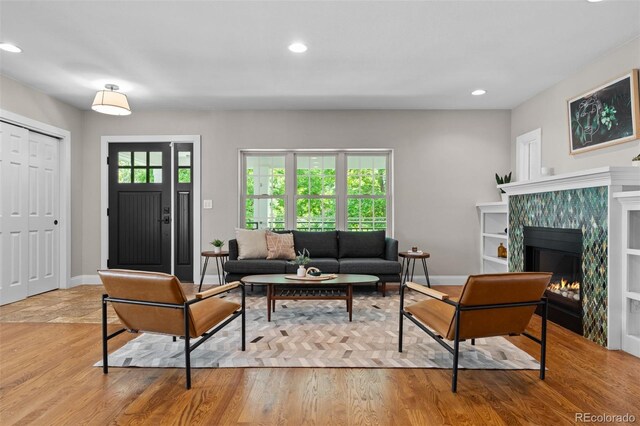 2485 S Fillmore St, Denver, CO 80210 - living area with recessed lighting, baseboards, light wood-type flooring, and a tiled fireplace