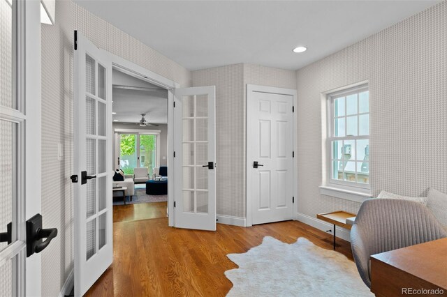 2485 S Fillmore St, Denver, CO 80210 - sitting room with french doors, wallpapered walls, wood finished floors, baseboards, and a ceiling fan