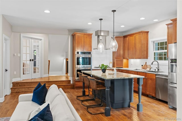 2485 S Fillmore St, Denver, CO 80210 - kitchen featuring stainless steel appliances, a sink, decorative backsplash, brown cabinetry, and recessed lighting