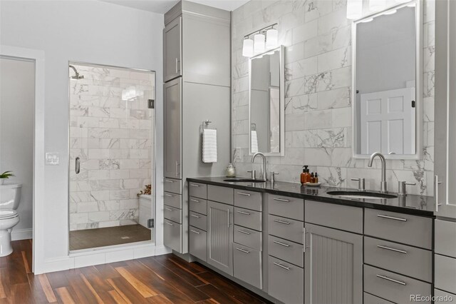 2485 S Fillmore St, Denver, CO 80210 - full bathroom featuring a shower stall, toilet, double vanity, and wood finished floors