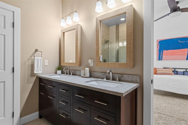 2485 S Fillmore St, Denver, CO 80210 - ensuite bathroom with double vanity, a textured wall, and an enclosed shower