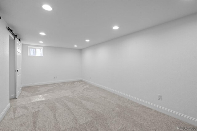 2485 S Fillmore St, Denver, CO 80210 - basement with recessed lighting, baseboards, light colored carpet, and a barn door