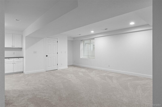 2485 S Fillmore St, Denver, CO 80210 - basement with light carpet, baseboards, and recessed lighting