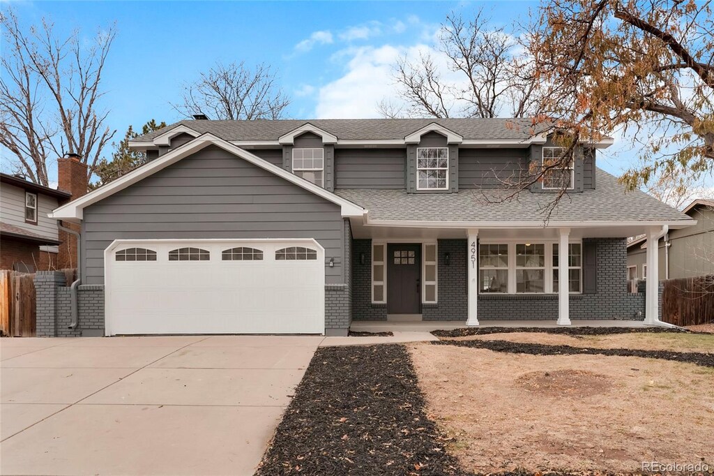 view of front of property with a porch and a garage