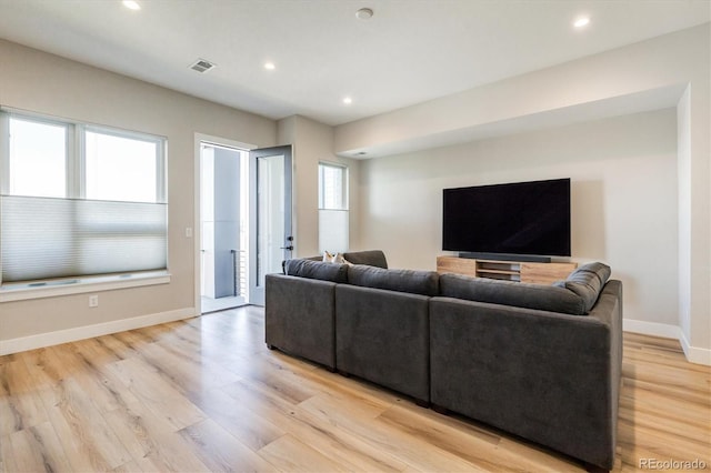 living room with light hardwood / wood-style flooring