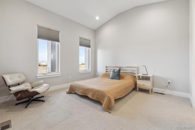 carpeted bedroom with lofted ceiling